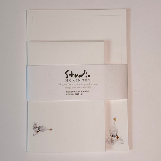 Studio McKinney A5 writing set, featuring a small duck illustration, wrapped in a white paper band featuring the brand name 'Studio McKinney' and 'Proudly Made in the UK'.